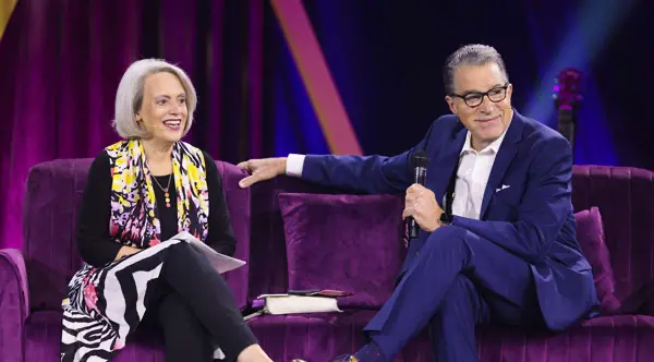 Nancy DeMoss Wolgemuth and Robert Wolgemuth seated on stage during a conversation, with Robert holding a microphone.